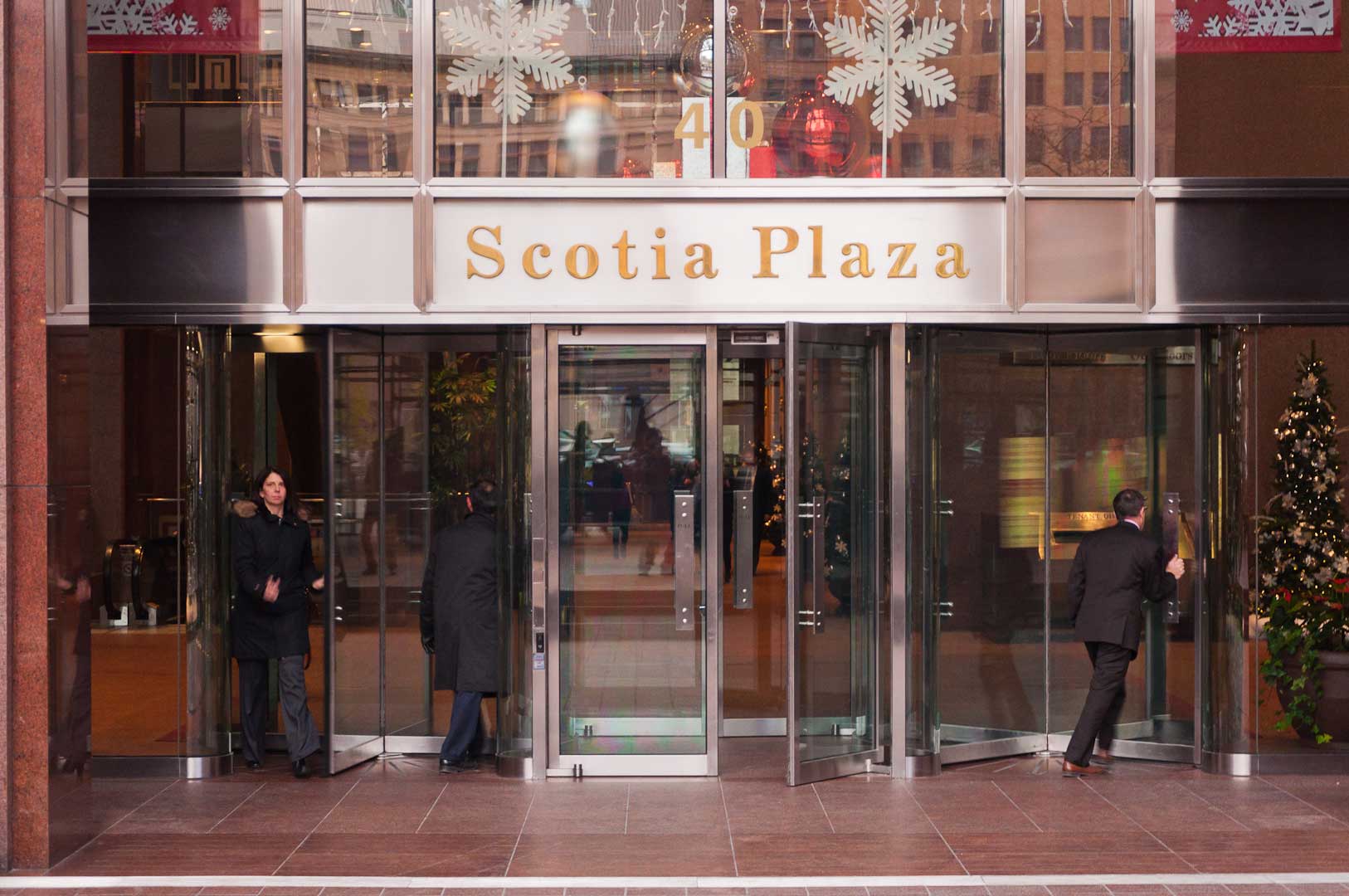 People going through the Revolving Doors at the Scotia Plaza in Toronto maintained by Explore1
