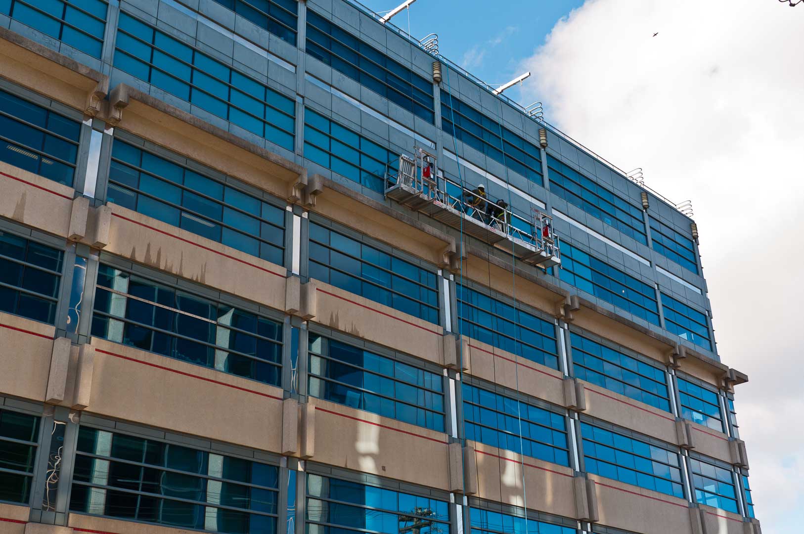 Building Facade Maintenance by High-Rise Experts Explore1.ca with Proper Safety Harnesses